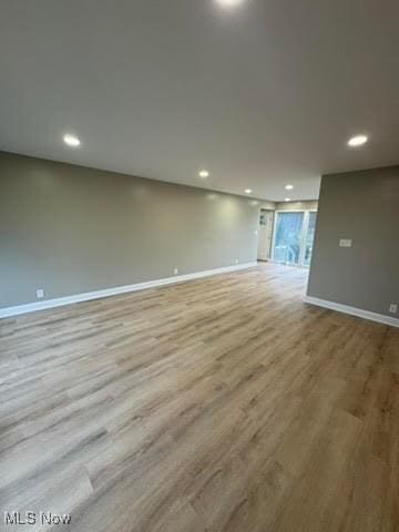 empty room with light hardwood / wood-style flooring