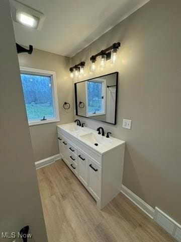 bathroom featuring hardwood / wood-style flooring and vanity