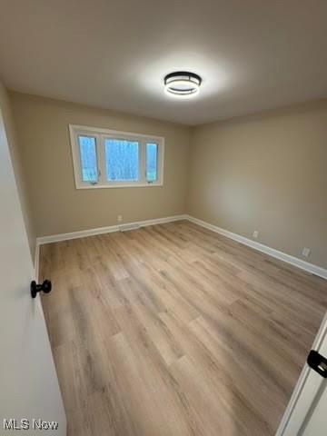 spare room with light hardwood / wood-style flooring