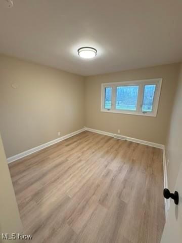 spare room with light hardwood / wood-style floors