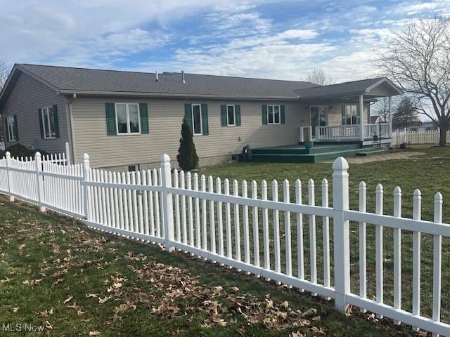 rear view of property with a yard