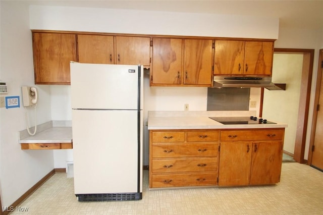 kitchen with white fridge and black electric stovetop