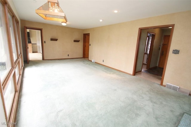 unfurnished room with light carpet