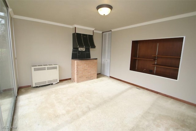 unfurnished bedroom with ornamental molding, radiator heating unit, and carpet flooring