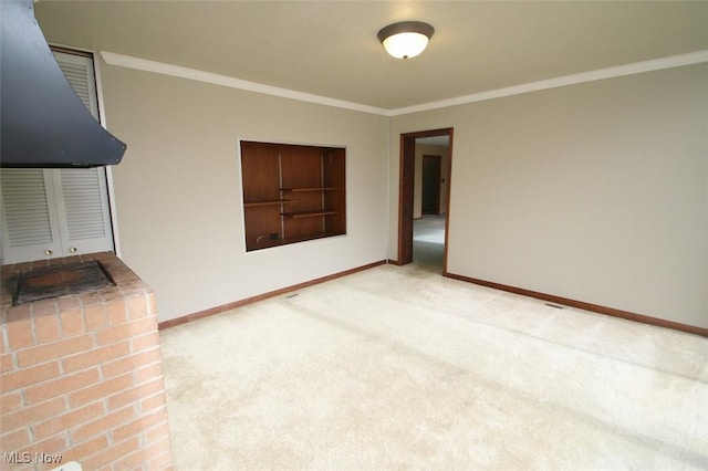 unfurnished living room with ornamental molding and carpet flooring