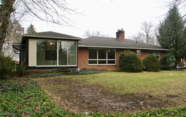 rear view of house with a yard