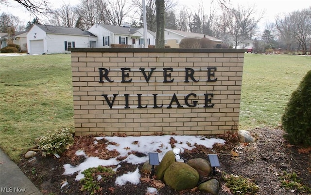 community sign featuring a lawn