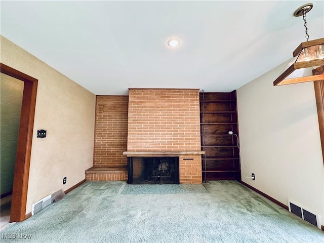 unfurnished living room with a brick fireplace and carpet floors