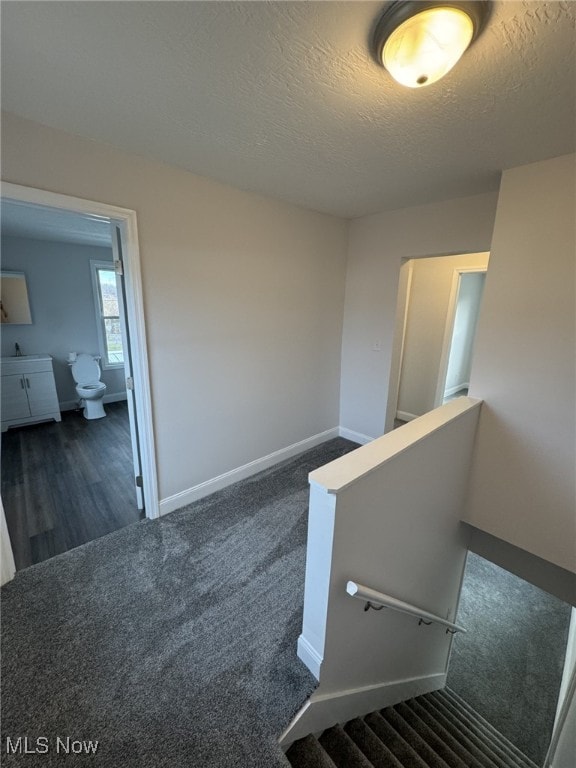 interior space with carpet and a textured ceiling