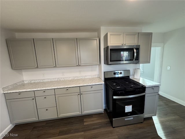 kitchen featuring gray cabinetry, dark hardwood / wood-style floors, and appliances with stainless steel finishes