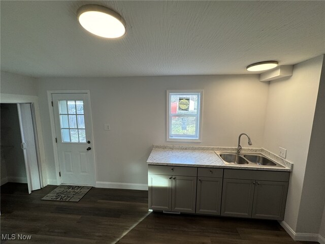 kitchen featuring dark hardwood / wood-style flooring, sink, gray cabinetry, and a textured ceiling