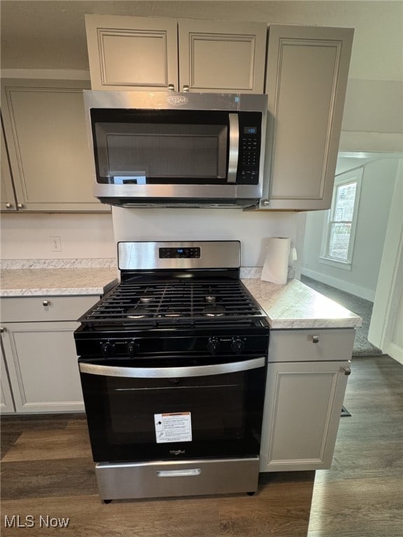 kitchen with dark wood-type flooring and stainless steel appliances