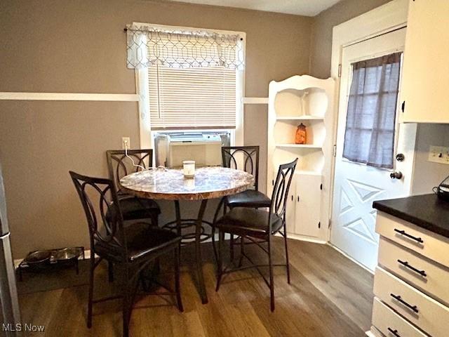 dining space with dark hardwood / wood-style floors