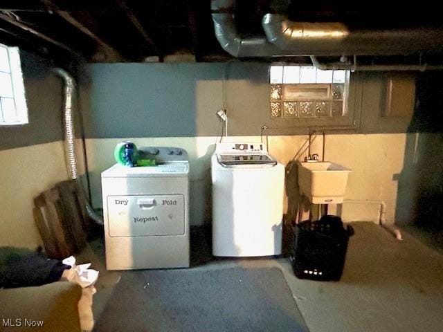 basement with separate washer and dryer and sink