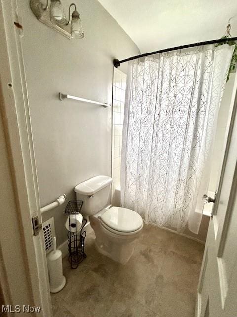 bathroom with shower / bath combo and toilet