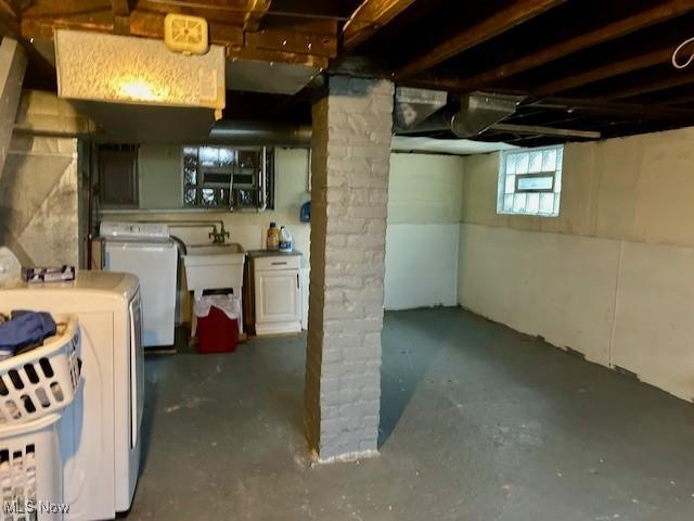 basement with sink and washer and dryer