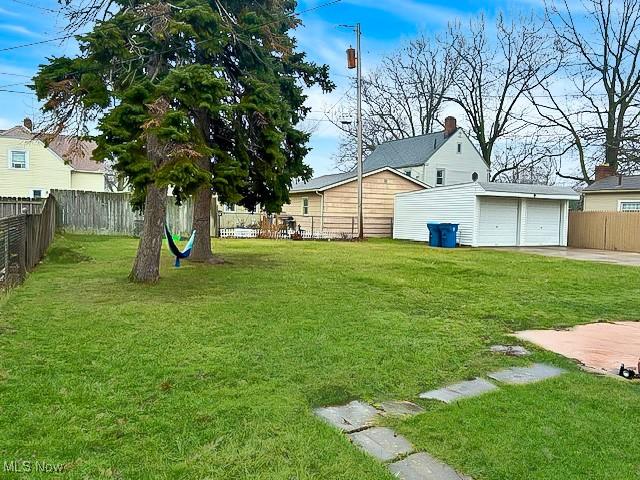 view of yard featuring an outbuilding and a garage