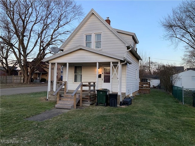 view of front of property with covered porch and a front lawn