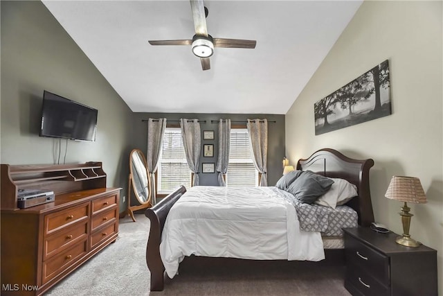 bedroom with vaulted ceiling, light colored carpet, and ceiling fan