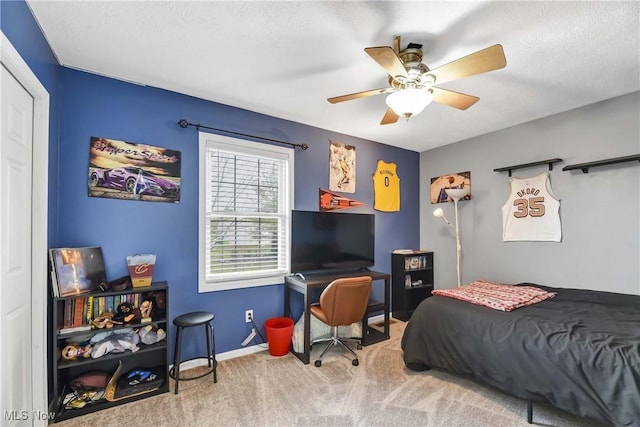 bedroom with carpet flooring, a textured ceiling, and ceiling fan