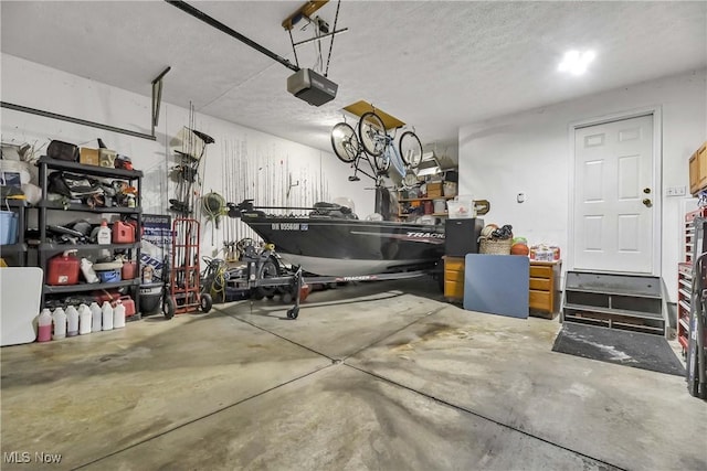 garage featuring a garage door opener and a workshop area