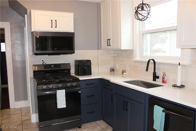 kitchen with white cabinetry, sink, tasteful backsplash, and stainless steel appliances