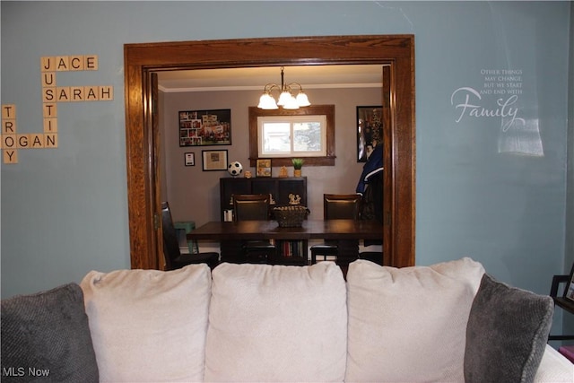 living room with ornamental molding and an inviting chandelier