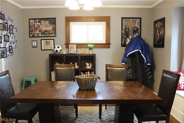 dining area featuring ornamental molding and a chandelier