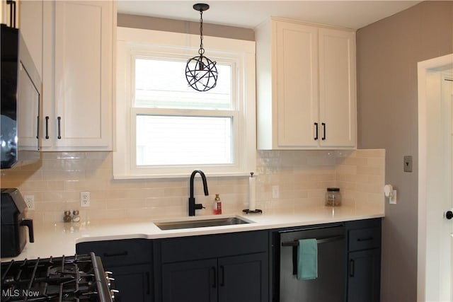 kitchen with pendant lighting, dishwasher, white cabinetry, sink, and decorative backsplash