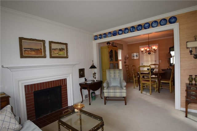 living room featuring ornamental molding, carpet, an inviting chandelier, and a brick fireplace