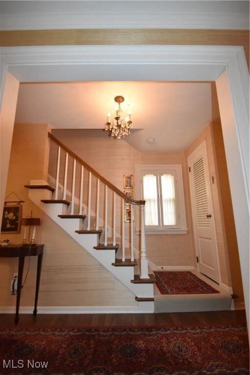 entrance foyer with wood-type flooring and a chandelier