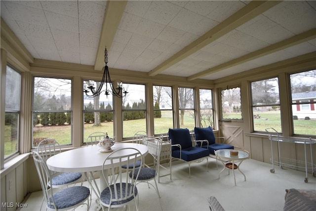 sunroom / solarium with beamed ceiling and a notable chandelier