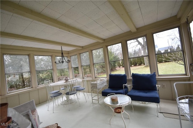 sunroom / solarium with an inviting chandelier and beam ceiling