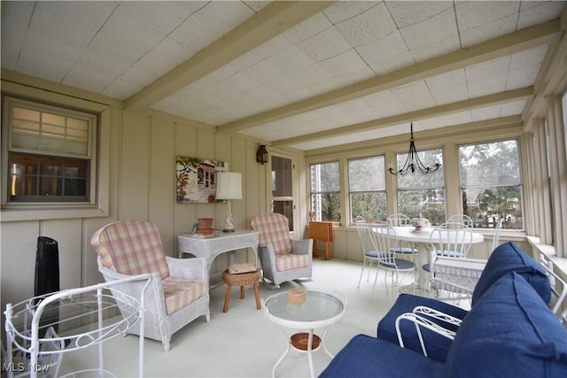 sunroom featuring a chandelier and beam ceiling