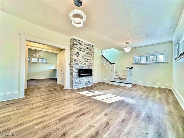 unfurnished living room with crown molding, wood-type flooring, and a fireplace