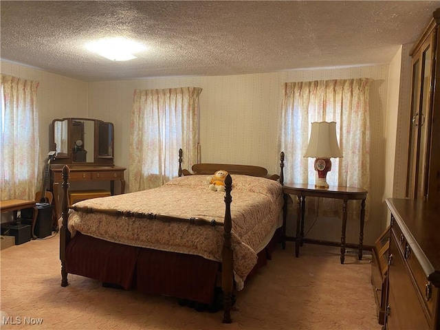 carpeted bedroom featuring a textured ceiling