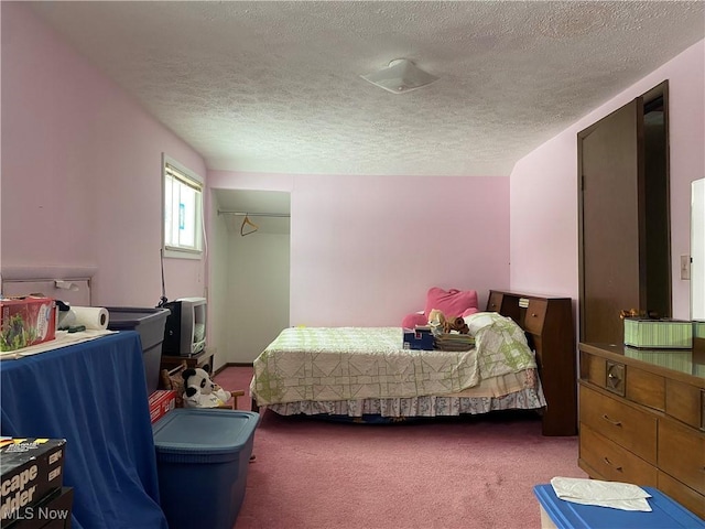 bedroom featuring carpet floors, a closet, and a textured ceiling