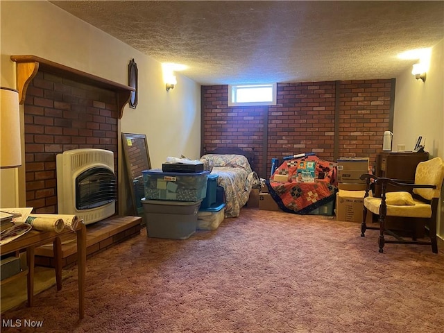 carpeted bedroom with heating unit, a fireplace, and a textured ceiling