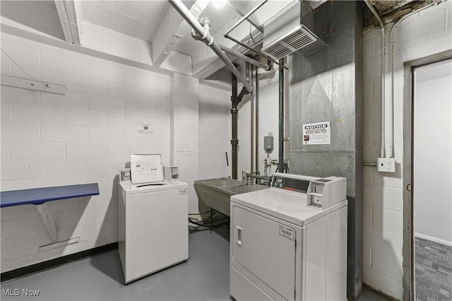 clothes washing area with sink and independent washer and dryer