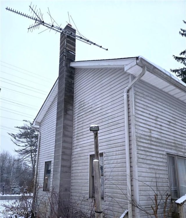 view of side of property featuring a chimney