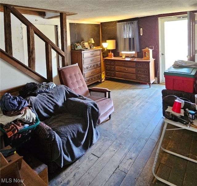 bedroom with wood-type flooring and a textured ceiling