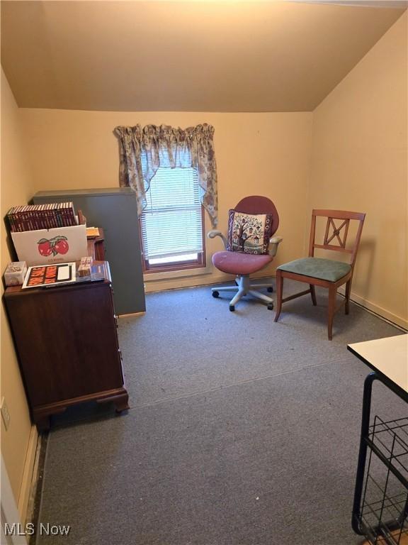 sitting room featuring vaulted ceiling, baseboards, and carpet floors