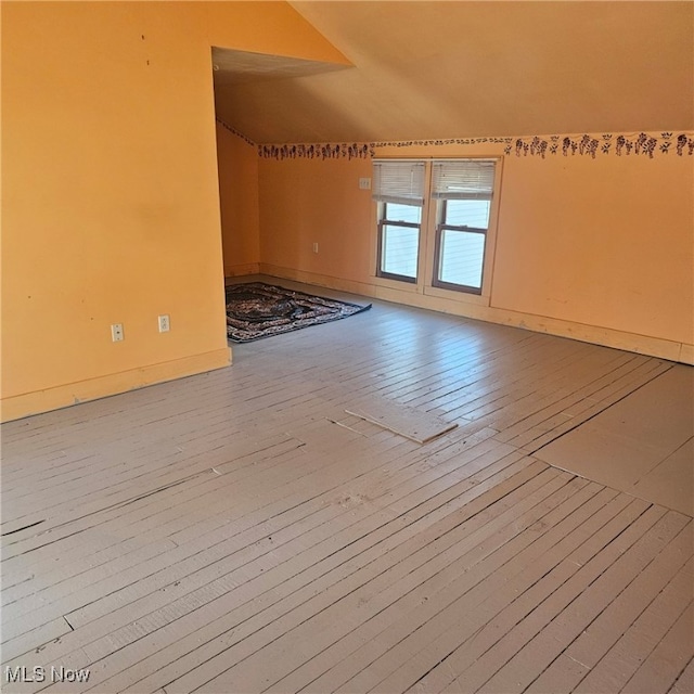 interior space with lofted ceiling and hardwood / wood-style flooring