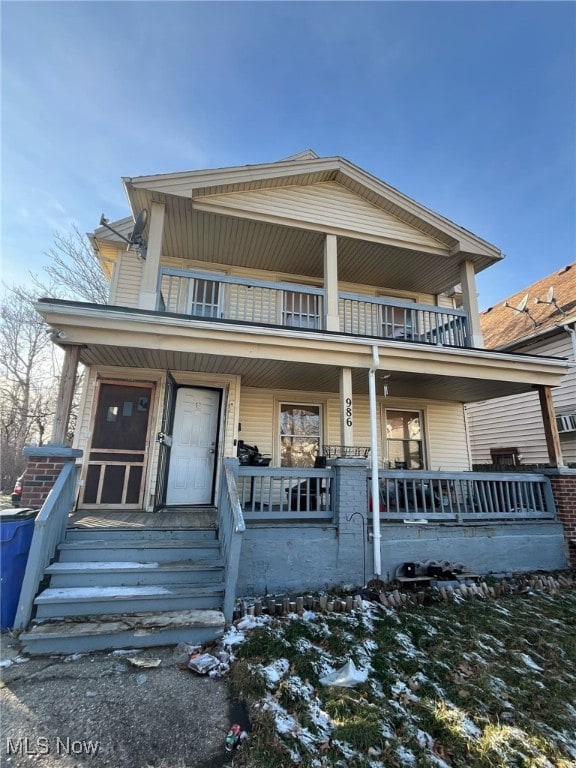 view of front of property with a balcony and covered porch