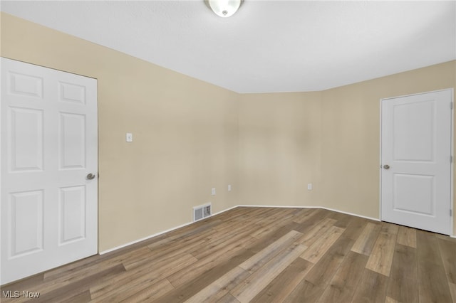 spare room featuring hardwood / wood-style floors