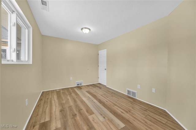 empty room with light hardwood / wood-style floors