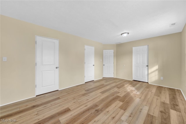 spare room featuring light hardwood / wood-style floors