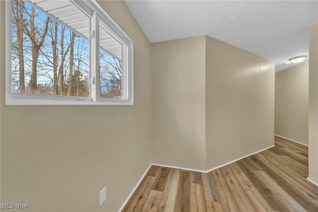 empty room with light hardwood / wood-style flooring