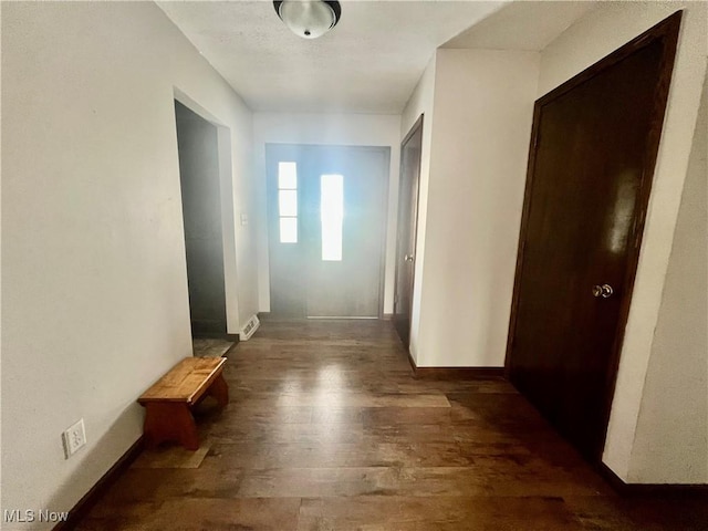 corridor featuring dark hardwood / wood-style floors