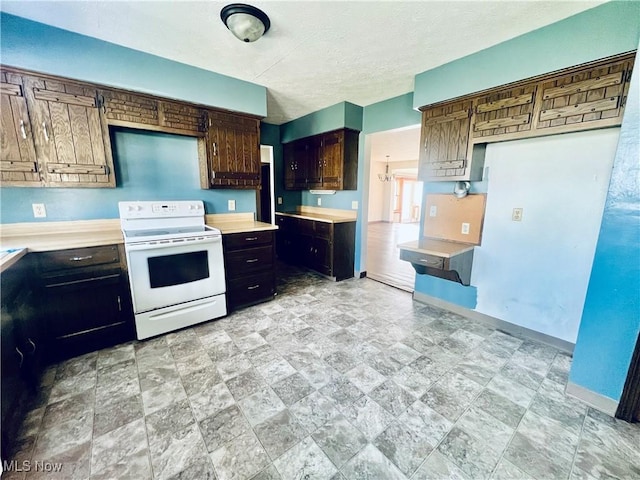 kitchen with white electric stove and a textured ceiling